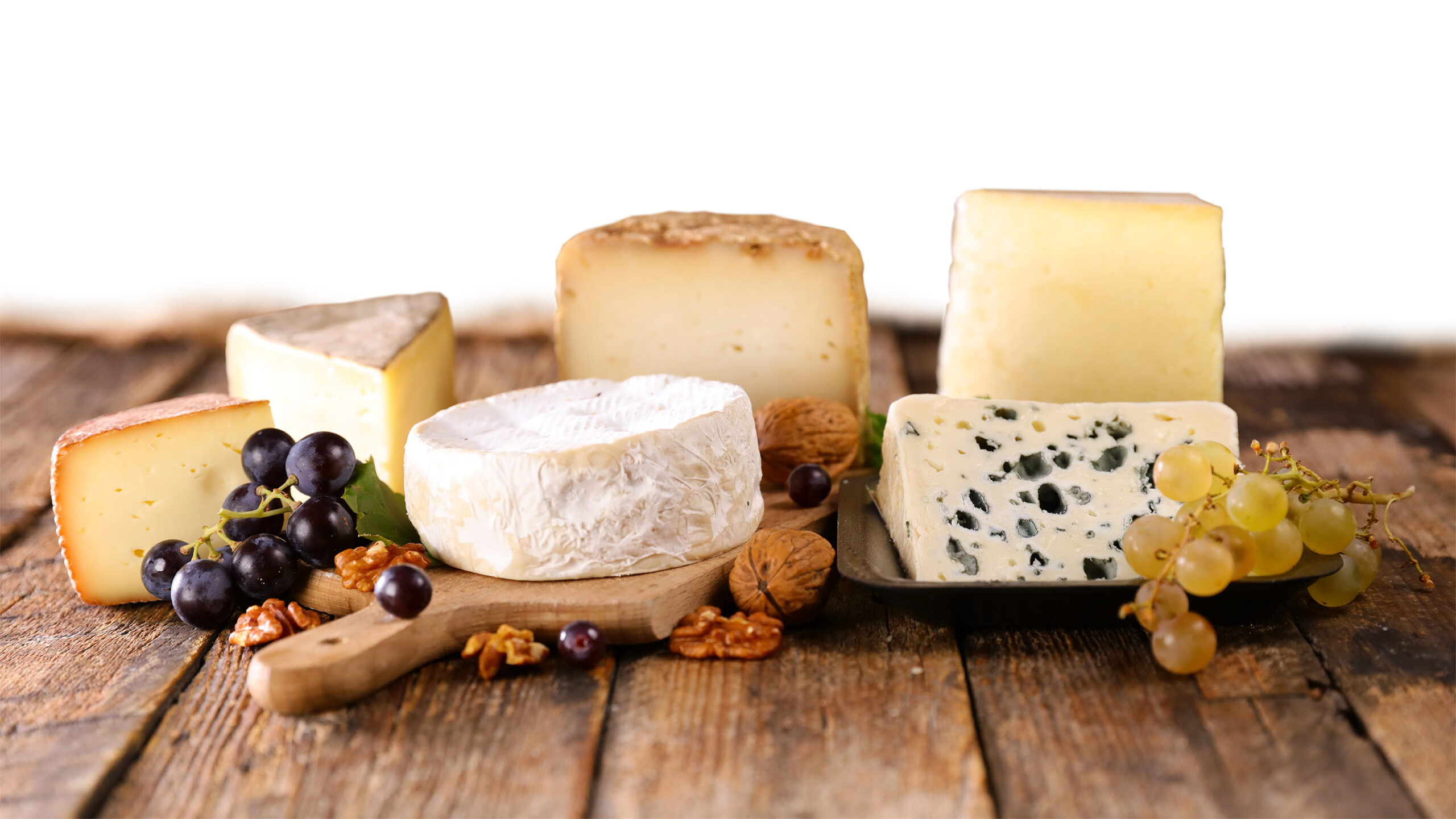 selection of french cheese on wood background